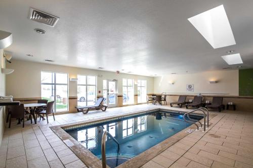 a large indoor pool with chairs and a table at Sleep Inn & Suites Haysville - Wichita South in Haysville