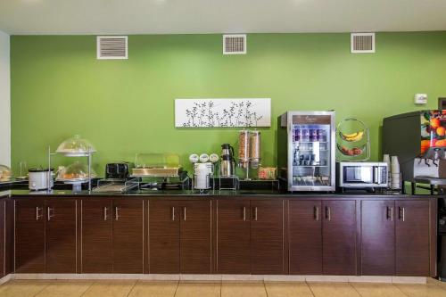 a kitchen with a counter top with a refrigerator at Sleep Inn & Suites Haysville - Wichita South in Haysville
