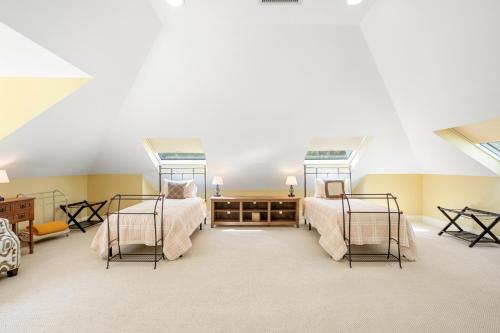 a bedroom with two beds in a attic at 7 Avocet Lane by Akers Ellis Rentals in Kiawah Island