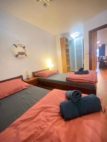 a bedroom with two beds and a mirror at Wave and Sun Apartment in Hel
