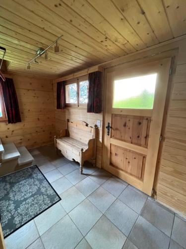 a wooden room with a tub and a window at Chalet Karin in Sankt Niklaus