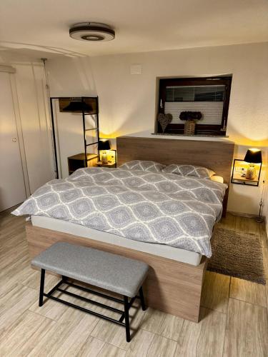 a bedroom with a large bed and a stool at Apartments Hana Bled in Bled