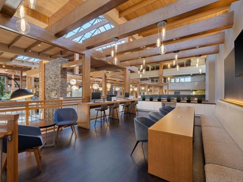 an office with wooden ceilings and tables and chairs at Crowne Plaza Suffern-Mahwah by IHG in Suffern