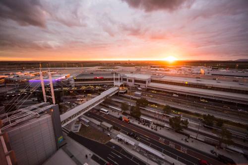 a view of a train station at sunset at ibis Budget - Melbourne Airport in Melbourne