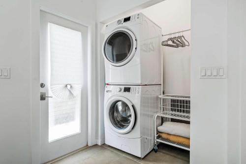 a white laundry room with a washer and dryer at Lincolnville Haven l Walk to DNTN l Dog Friendly in Saint Augustine