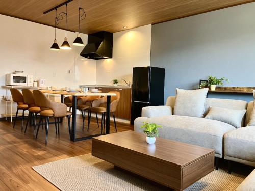 a living room with a couch and a table at HAOSTAY Villa Oishi Park in Fujikawaguchiko