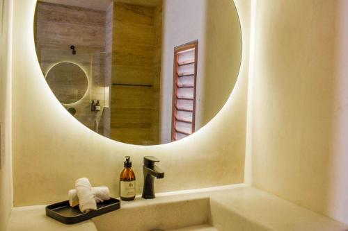 a bathroom with a sink with a mirror at Studio in La Veleta with private rooftop in Tulum
