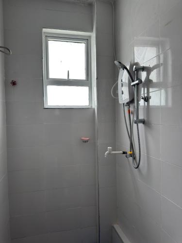 a shower in a bathroom with a window at 1 bedroom beach apartment-Swan Homes in Malindi
