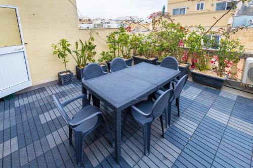 a black table and chairs sitting on a patio at Quiet double ensuite room in Sliema