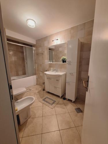 a bathroom with a sink and a toilet at Quiet, Family-Friendly House with Garden & Parking in Skopje