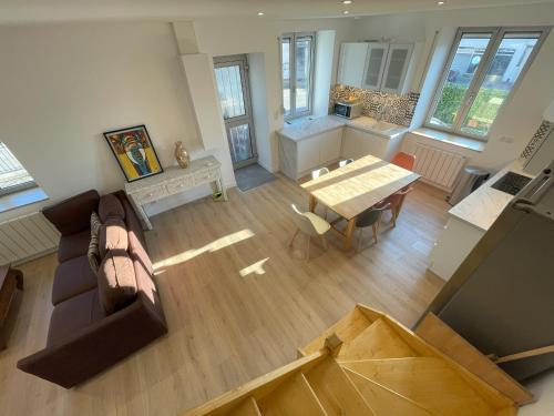 an overhead view of a living room with a couch and a table at Duplex Vittel Centre Ville in Vittel