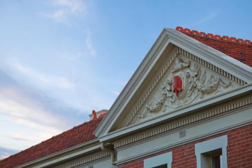 a building with a red crest on top of it at Old Fire Station Backpackers in Fremantle