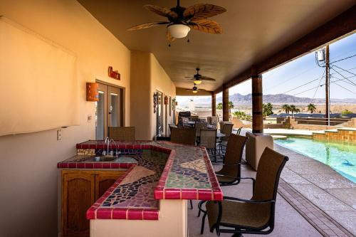 a kitchen with a table and chairs and a pool at Havasu River Stay Pool Spa OutdoorTV Views in Lake Havasu City