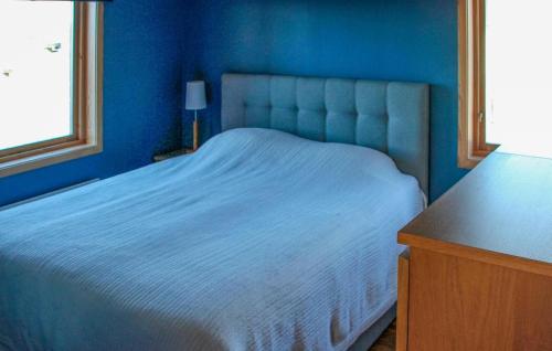 a blue bedroom with a bed and a window at Amazing Home In Nässjö With Wifi in Nässjö