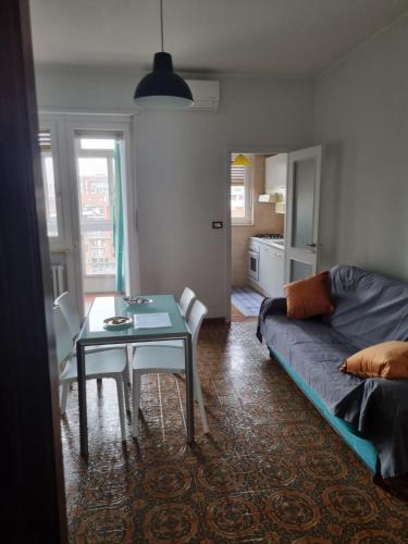 a living room with a table and a couch at A Casa di Simo in Turin