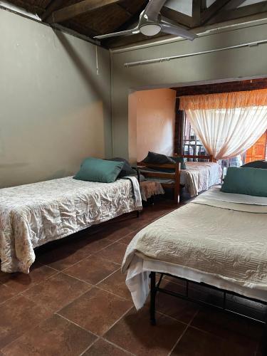 a bedroom with two beds and a window at Sweet Dream Overnight 2 in Postmasburg