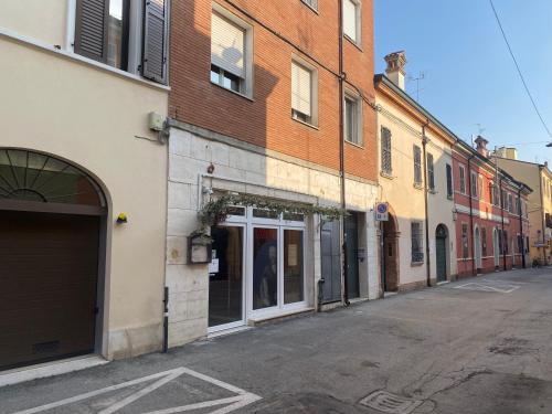 an empty street in a city with buildings at Dimora Pasolini in Ravenna