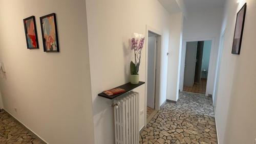 a hallway with a vase of flowers on a table at Dimora Pasolini in Ravenna