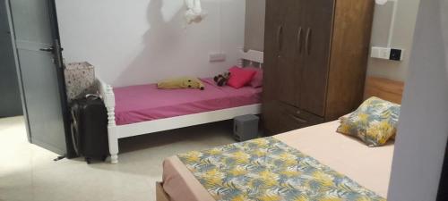 a bedroom with a bed with a pillow on it at Villasjohnclair in Eau Vanée