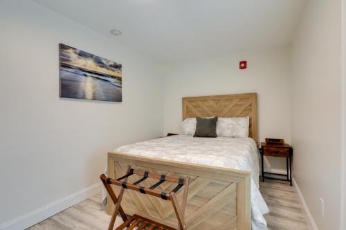 a small bedroom with a bed and a chair at Pet-Friendly Wareham Retreat Near Onset Beach! in Wareham