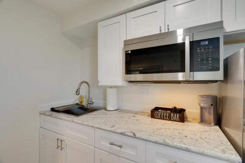 a kitchen with white cabinets and a silver microwave at 3 Mi to Main Street Newly Renovated Wareham Apt! in Wareham
