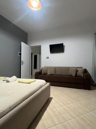 a living room with a bed and a couch at House Pollo in Ksamil