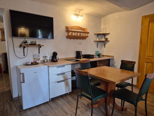a kitchen with a table and a white refrigerator at Slovenian House Vida in Bled
