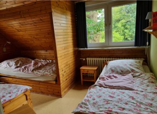 two twin beds in a room with two windows at Ferienhof Bisdorf "Steilküste" in Bisdorf