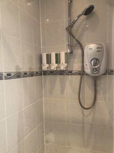 a shower with a shower head in a bathroom at Spindrift Guest house in Great Yarmouth