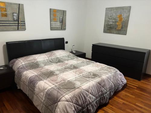 a bedroom with a bed and two night stands at Appartamento vista Lago Sarnico in Sarnico
