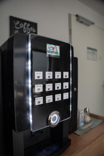 a black microwave with stickers on the side of it at Hotel Garni Fischerfleck in Ismaning near Munich in Ismaning
