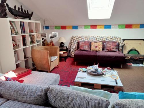 un salon avec un canapé et une table dans l'établissement Au jardin croix roussien, à La Celle-sous-Gouzon