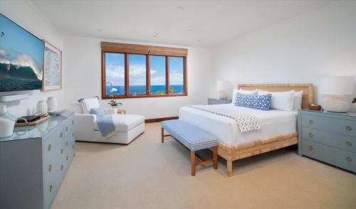 a bedroom with a bed and a chair and a window at Freshly Renovated, Spectacular Ocean Views, Ultra-Luxe Blue Ocean Suite H401 in Wailea