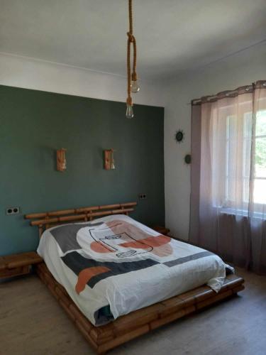 - une chambre avec un lit doté d'un cadre en bois dans l'établissement Maison chaleureuse, à Saint-Quentin-la-Poterie