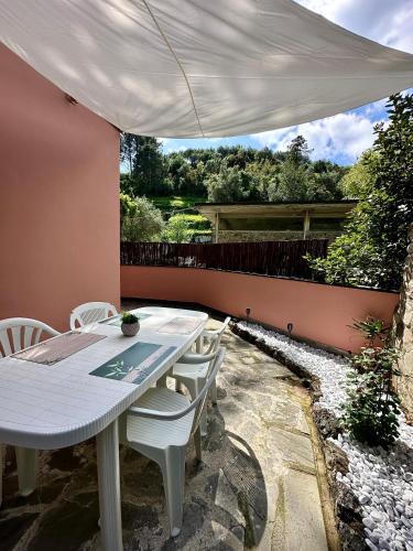 a white table and white chairs on a patio at Terrace & Parking - Holiday Home near Fegina Beach in Monterosso al Mare