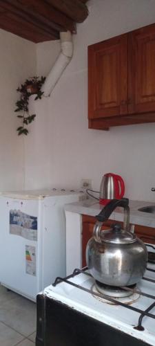 a tea kettle on top of a stove in a kitchen at Monoambiente Blanca in Concordia