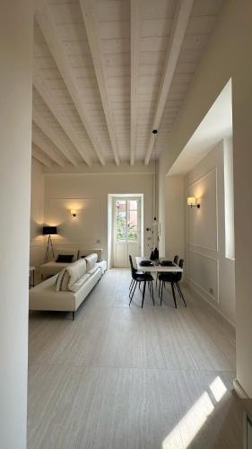 a living room with a couch and a table at Il Giardino - Holiday lake home in Iseo