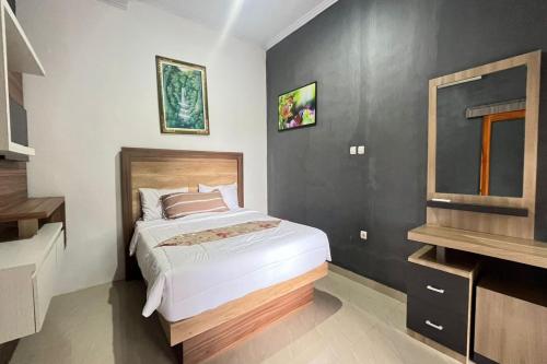 a bedroom with a bed and a window in it at Belvilla Moksha Haven Pandawa BaliNearNirwana Garden Bali in Jembrana
