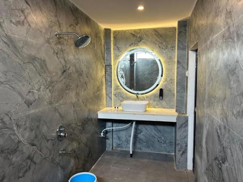 a bathroom with a sink and a mirror at Hotels7Apple in Mahoba