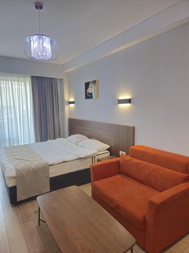 a hotel room with a bed and a couch at Bakuriani Crystal in Bakuriani