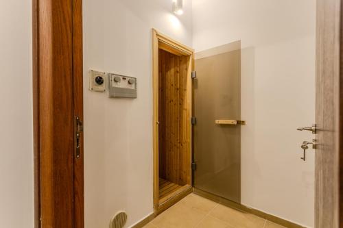 a bathroom with a mirror and a wooden door at Kallisti Beach & Spa Villa - A Luxury Seaside Retreat in Lachi