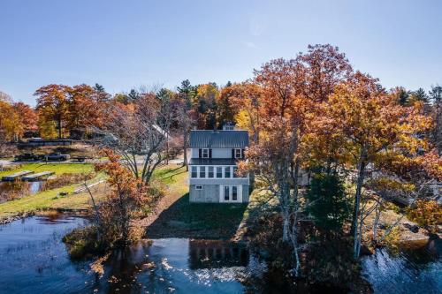 an aerial view of a house on a hill next to a river at Spacious Lakeside Retreat 4-Bedroom Game Room in Orono