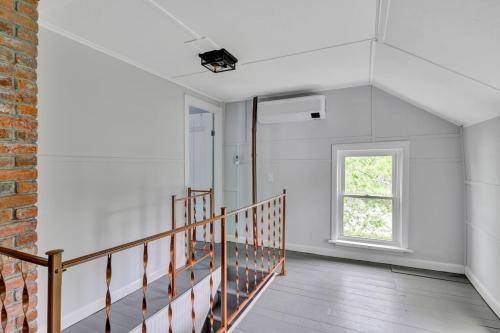 an empty room with a staircase and a window at Spacious Lakeside Retreat 4-Bedroom Game Room in Orono