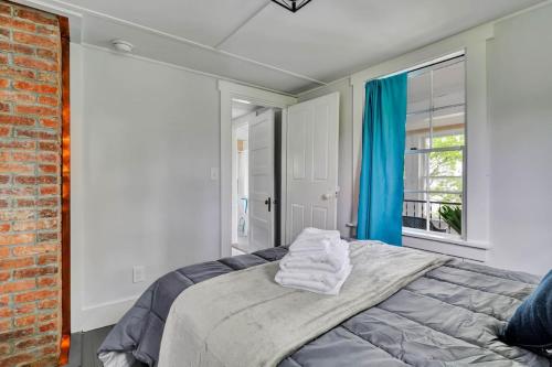 a bedroom with a bed with blue curtains and a window at Spacious Lakeside Retreat 4-Bedroom Game Room in Orono