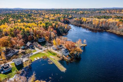 an aerial view of a house on an island in a lake at Spacious Lakeside Retreat 4-Bedroom Game Room in Orono