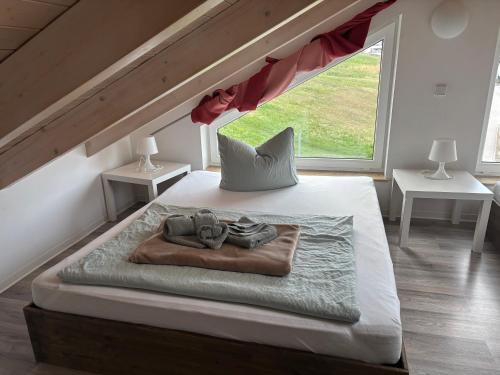 a bedroom with a bed with a large window at Ferienwohnung mit Sauna -Marina Mücheln Geiseltalsee in Mücheln