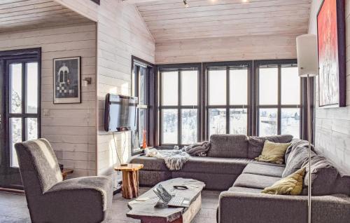 a living room with a couch and a tv at Amazing Home In Jøsenfjorden With Sauna in Gullingen