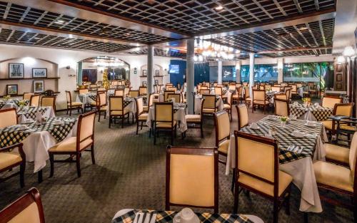a dining room with tables and chairs in a restaurant at InHouse Select Hacienda Tres Rios Hotel Culiacán in Culiacán