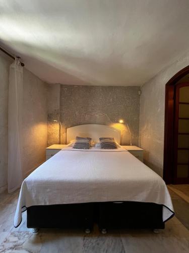 a bedroom with a large white bed with two pillows at Castle81homes White , Sea view house in Marmaris