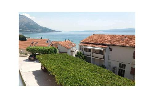 a view of a house with the ocean in the background at Stunning Apartment In Duce With Wifi in Duće